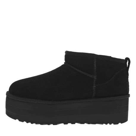 Boots en cuir noires à semelle à talon semi-compensée et fourrure