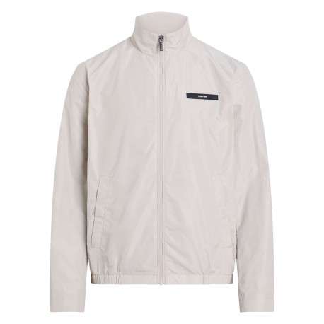 Veste blanche légère avec un aspect satiné un col montant et des poches