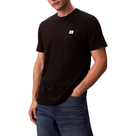 T-shirt en coton noir uni avec un petit patch brodé et à col rond
