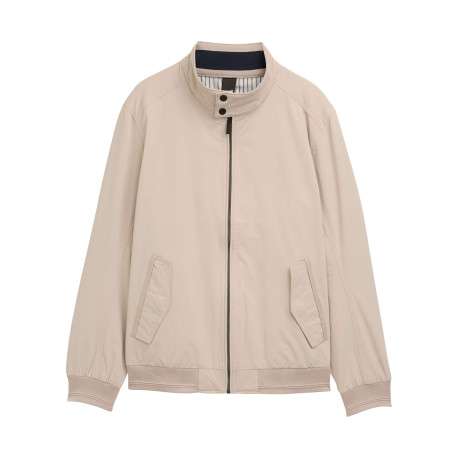 Blouson beige uni avec une coupe droite et deux poches raglan à l’avant