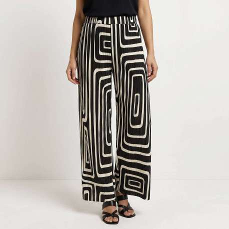 Pantalon écru et noir plissé pourvu d'un motif géométrique et d'une coupe ample - Image 3