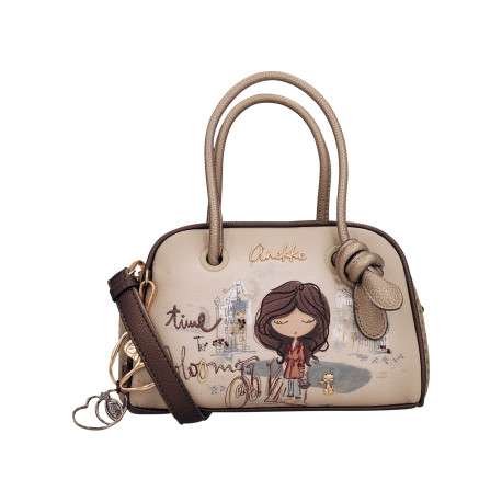 Sac à main beige pourvu d'une bandoulière amovible et de deux anses rondes